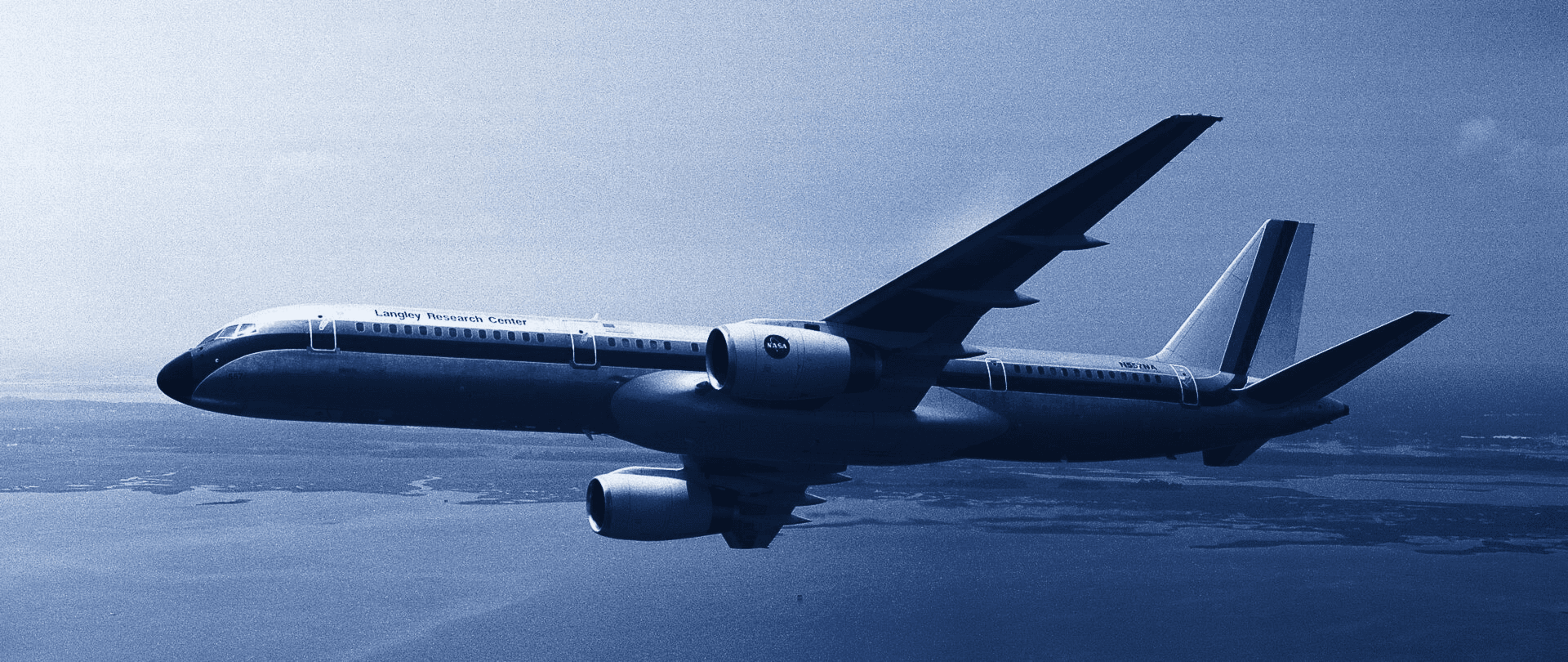 Boeing 757 in flight over open water